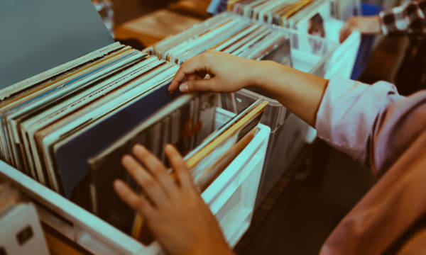 Woman is choosing a vinyl record in a musical store