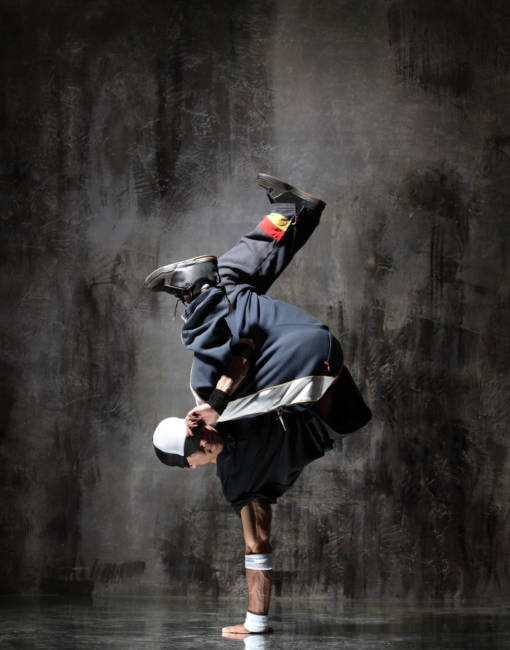 modern style dancer posing on dirty grunge background