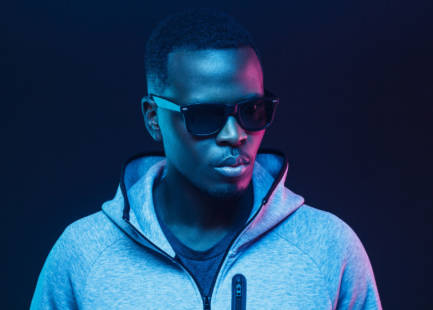 Close-up portrait of stylish black man, wearing hoodie and sunglasses