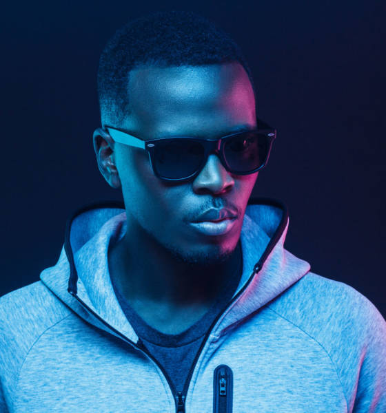 Close-up portrait of stylish black man, wearing hoodie and sunglasses