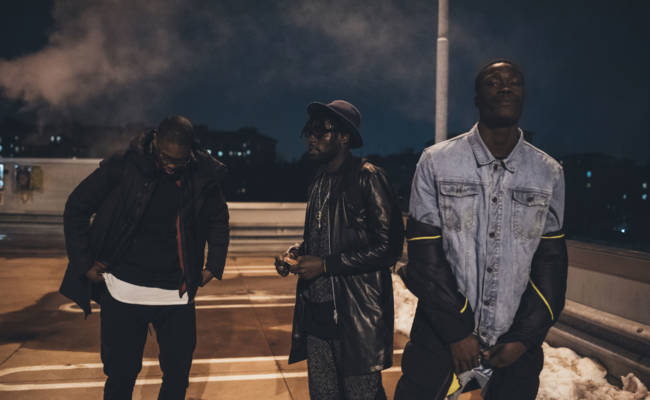 three young men posing outdoor looking camera serious - rap crew, gang, swag concept