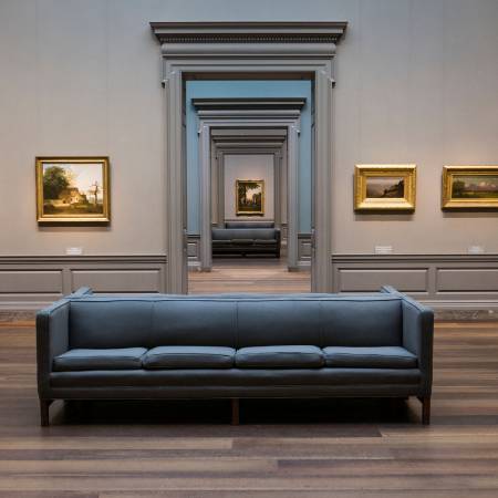 Symmetric view of a museum room looking through multiple doors