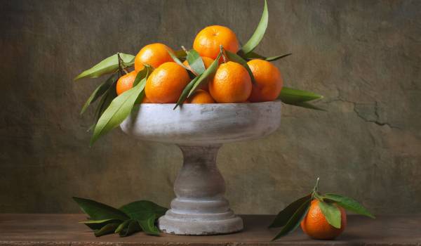 Vintage still life with tangerines in vase for fruits