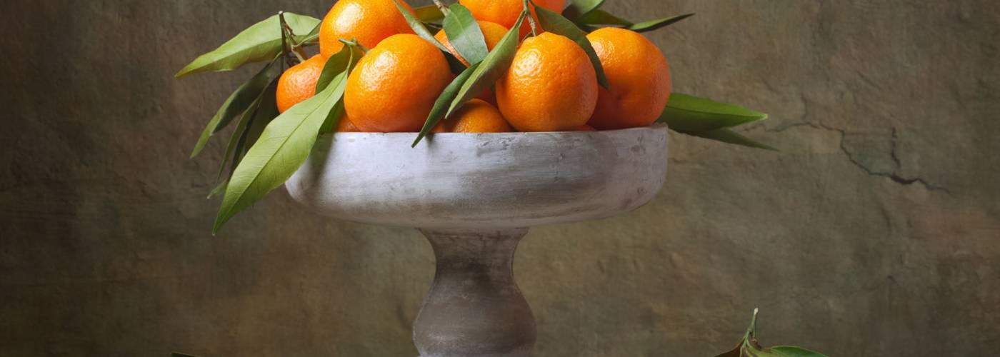 Vintage still life with tangerines in vase for fruits