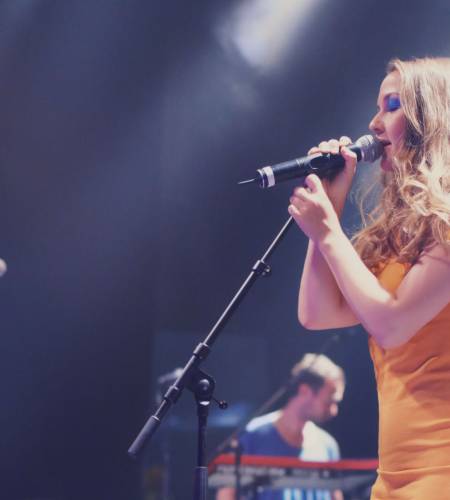 A band playing on stage at a concert.